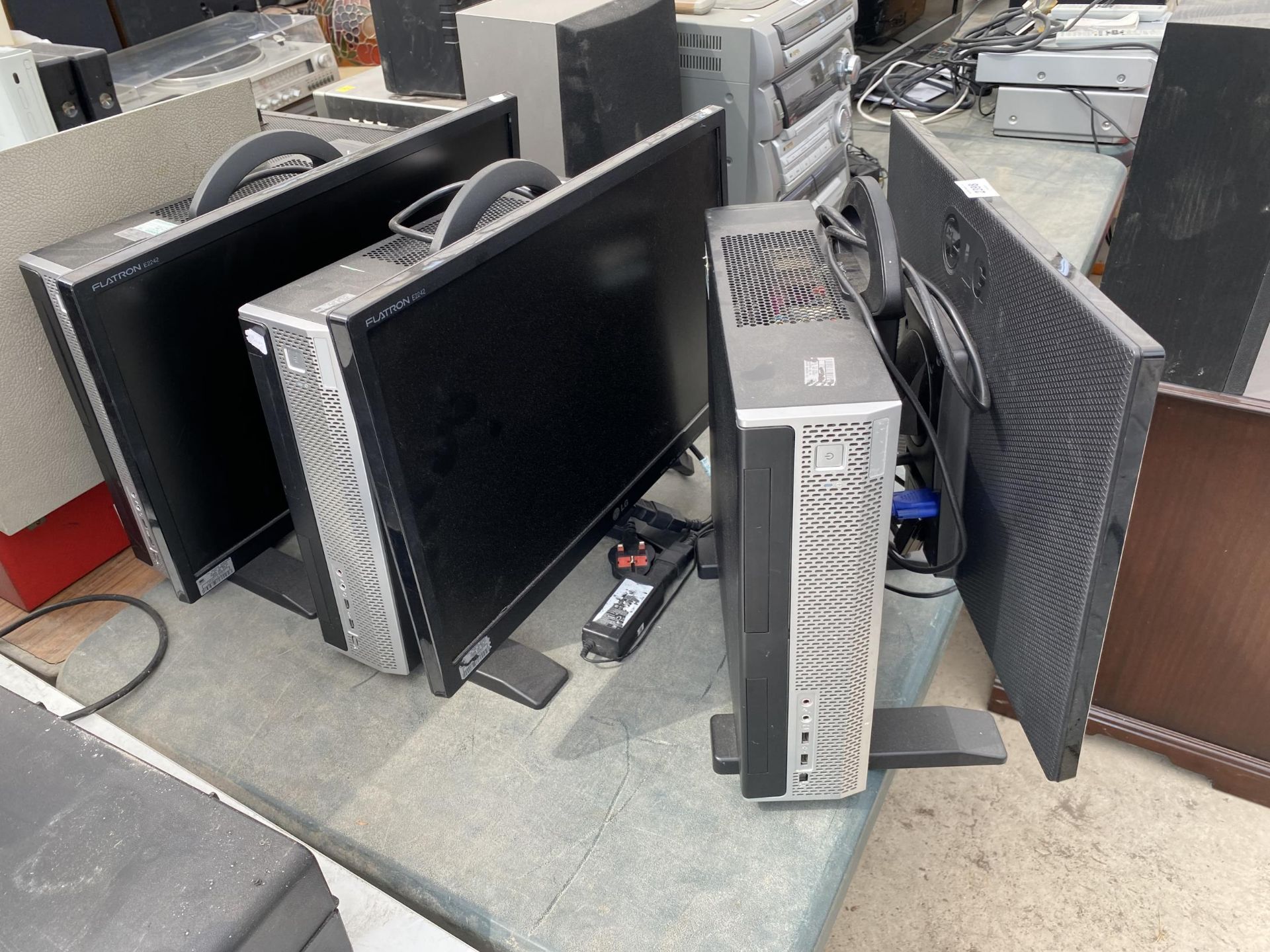 THREE LG COMPUTER MONITORS WITH ATTATCHED TOWERS