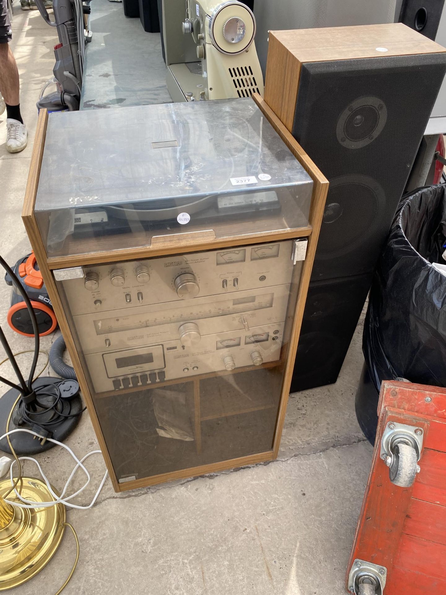 A TEAK RECORD CABINET WITH AN ASSORTMENT OF AMSTRAD STEREO EQUIPMENT AND TWO SPEAKERS