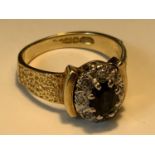 AN 18 CARAT GOLD RING WITH A CENTRE SAPPHIRE SURROUNDED BY DIAMONDS SIZE J