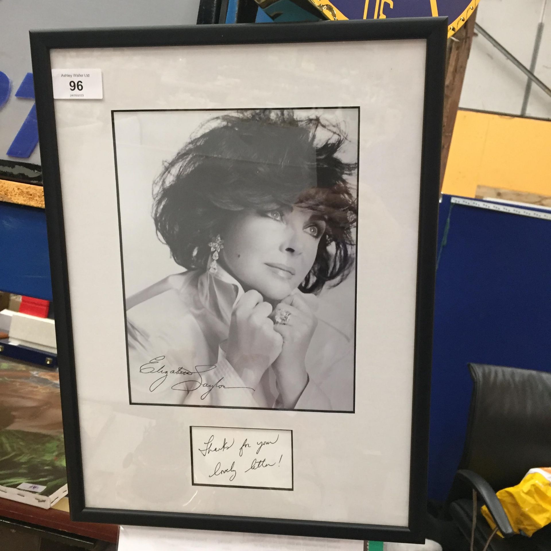 A FRAMED AND SIGNED ELIZABETH TAYLOR PHOTO