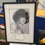 A FRAMED AND SIGNED ELIZABETH TAYLOR PHOTO