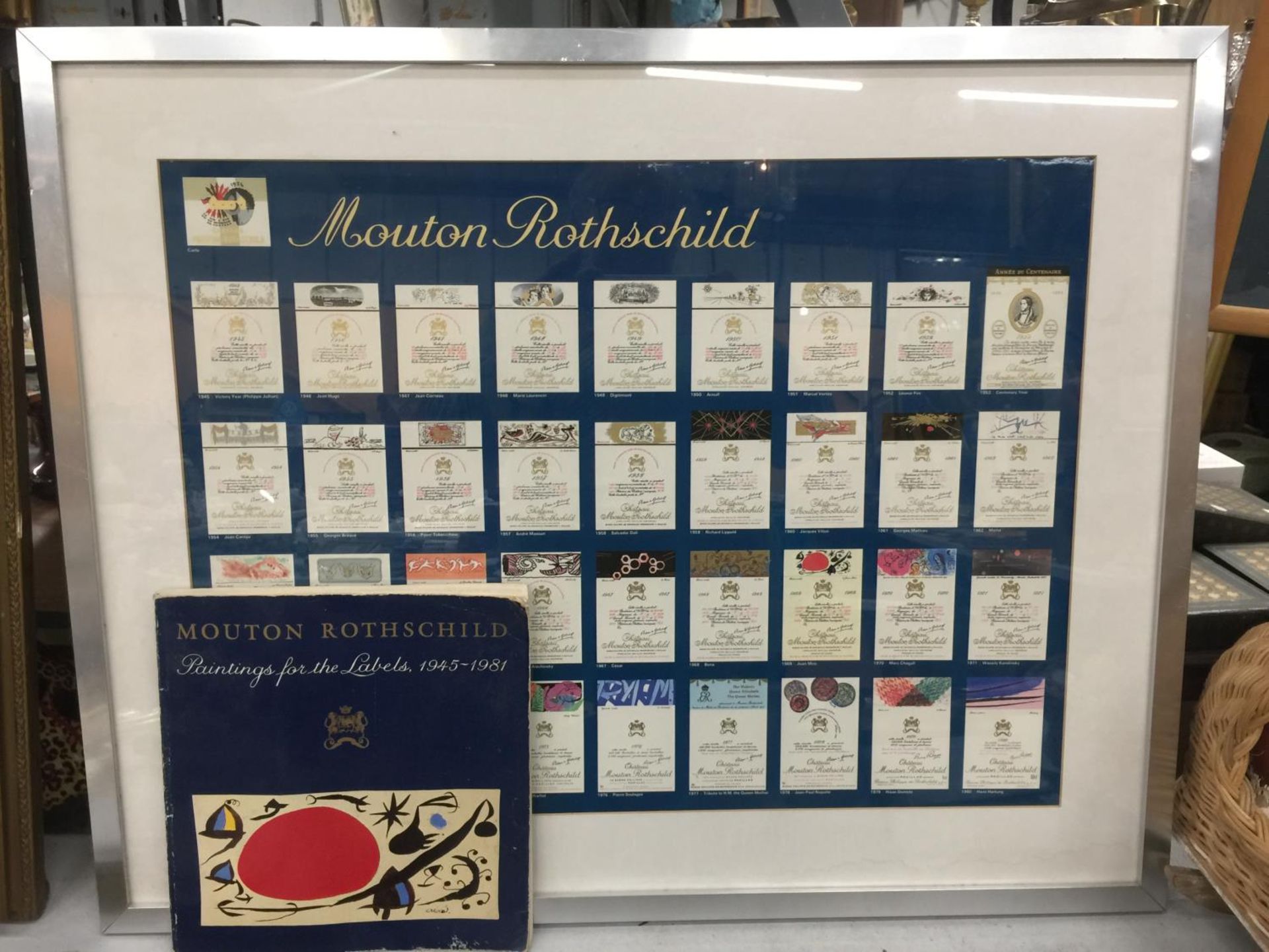 A RARE FRAMED QUANTITY OF VINTAGE MOUTON ROTHSCHILD WINE LABELS ACCOMPANIED WITH THE PAINTINGS FOR