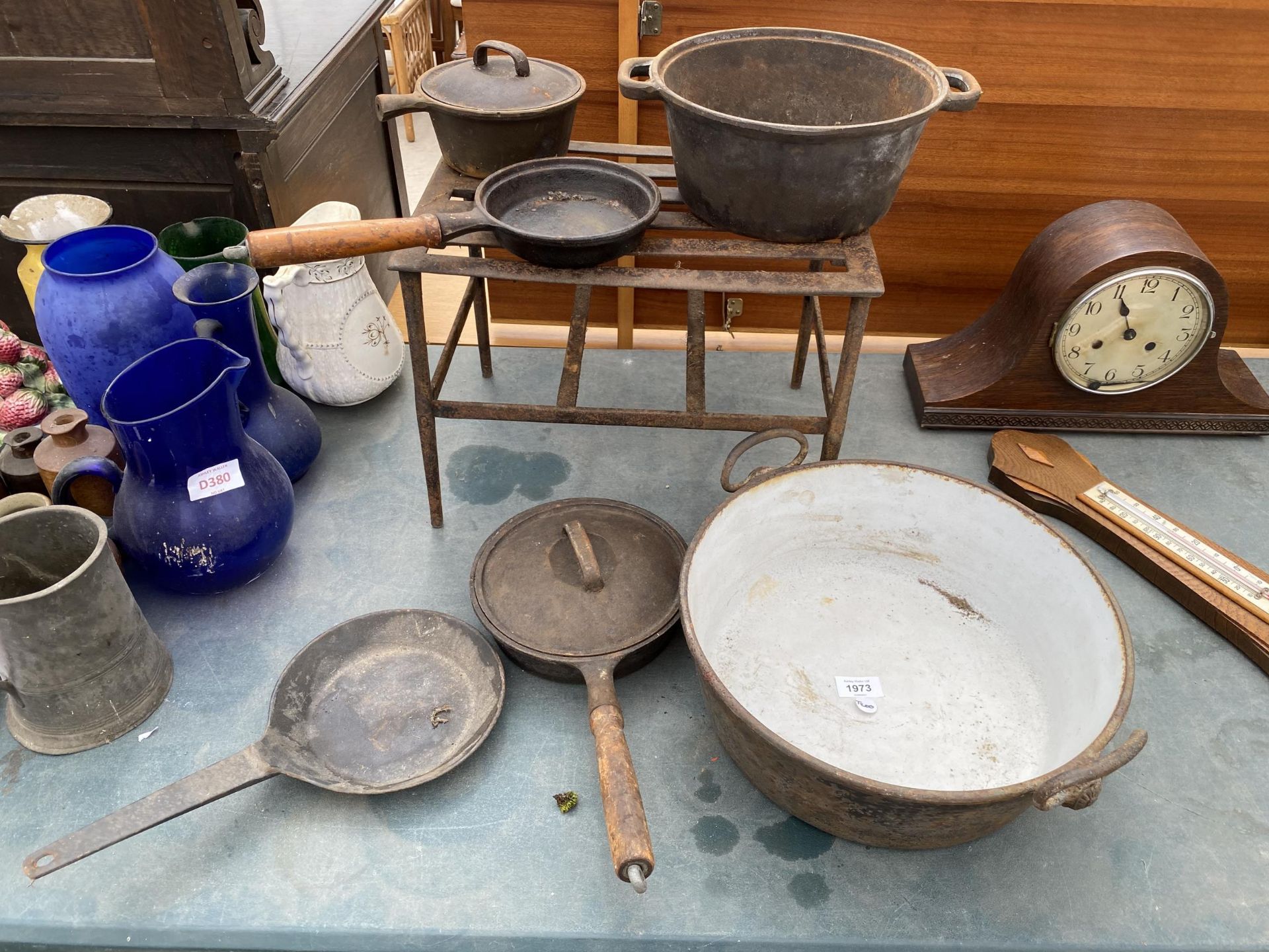A MIXED LOT OF CAST KITCHEN PANS, STAND ETC