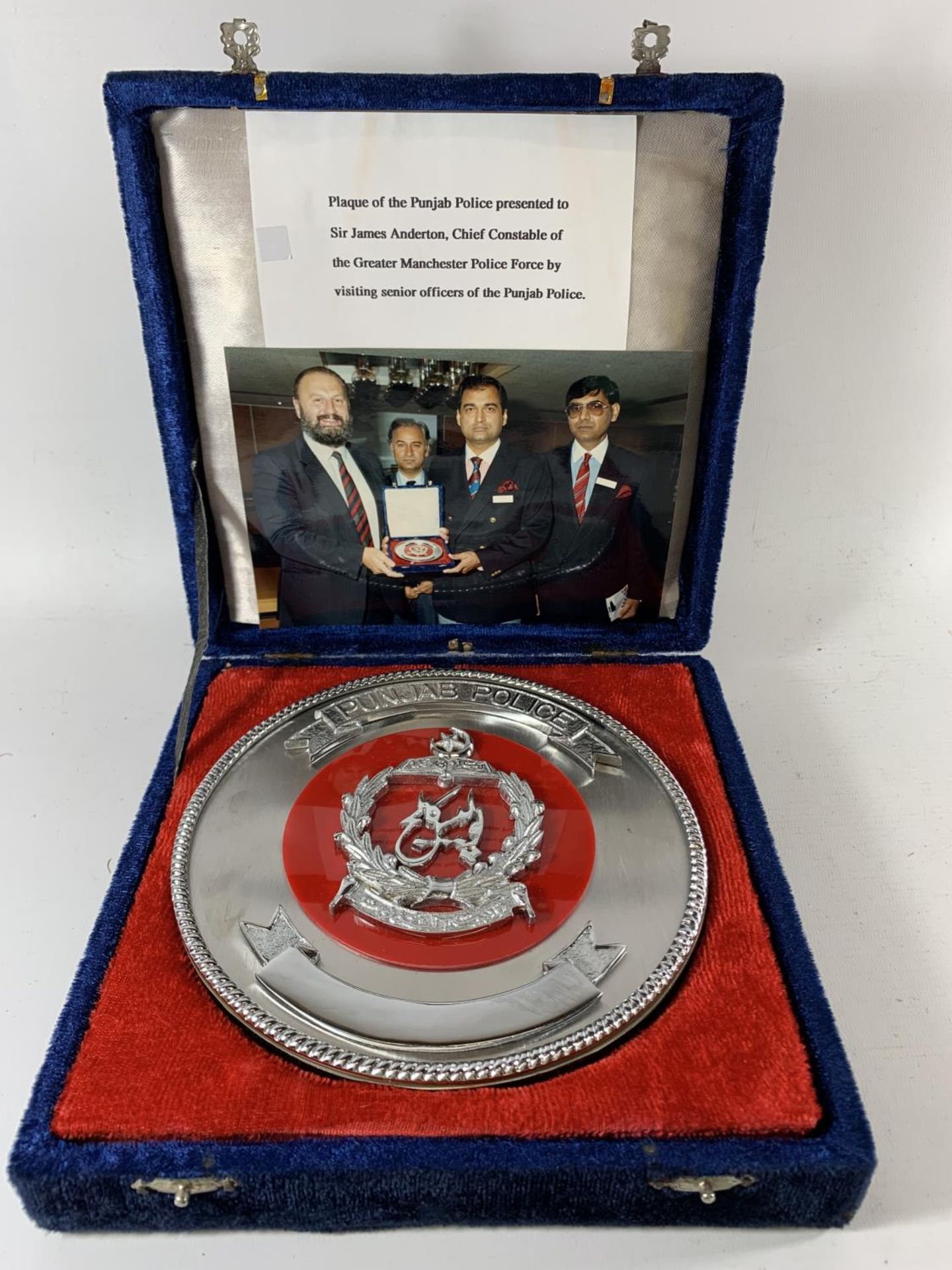 * A LARGE CASED PUNJAB POLICE PLAQUE WITH PRESENTATION CARD TO SIR JAMES ANDERTON AND TWO PHOTOS