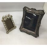 A DECORATIVE HALLMARKED SILVER PHOTO FRAME WITH RIBBON DESIGN AND FURTHER METAL DOVE DESIGN PHOTO