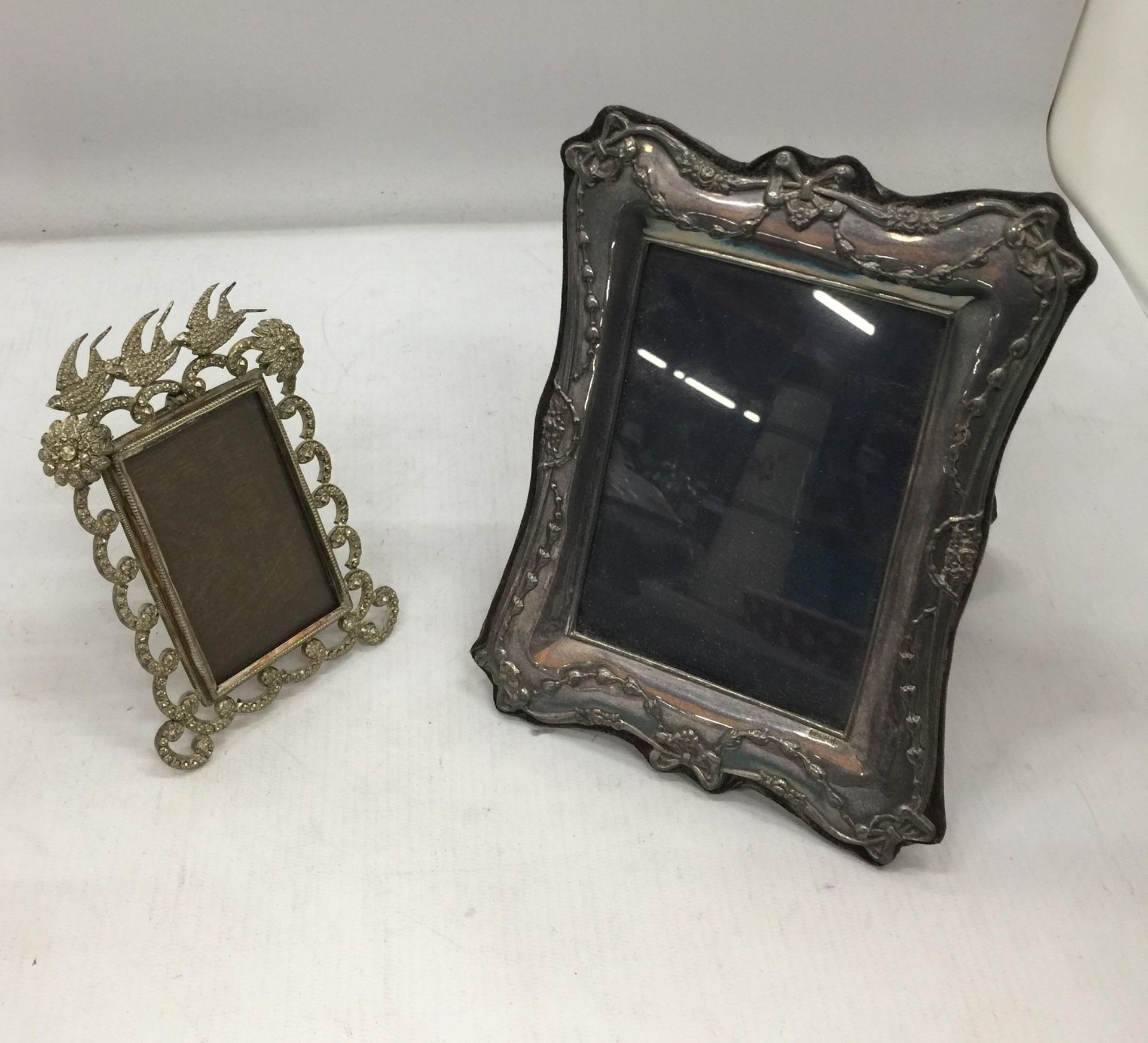 A DECORATIVE HALLMARKED SILVER PHOTO FRAME WITH RIBBON DESIGN AND FURTHER METAL DOVE DESIGN PHOTO