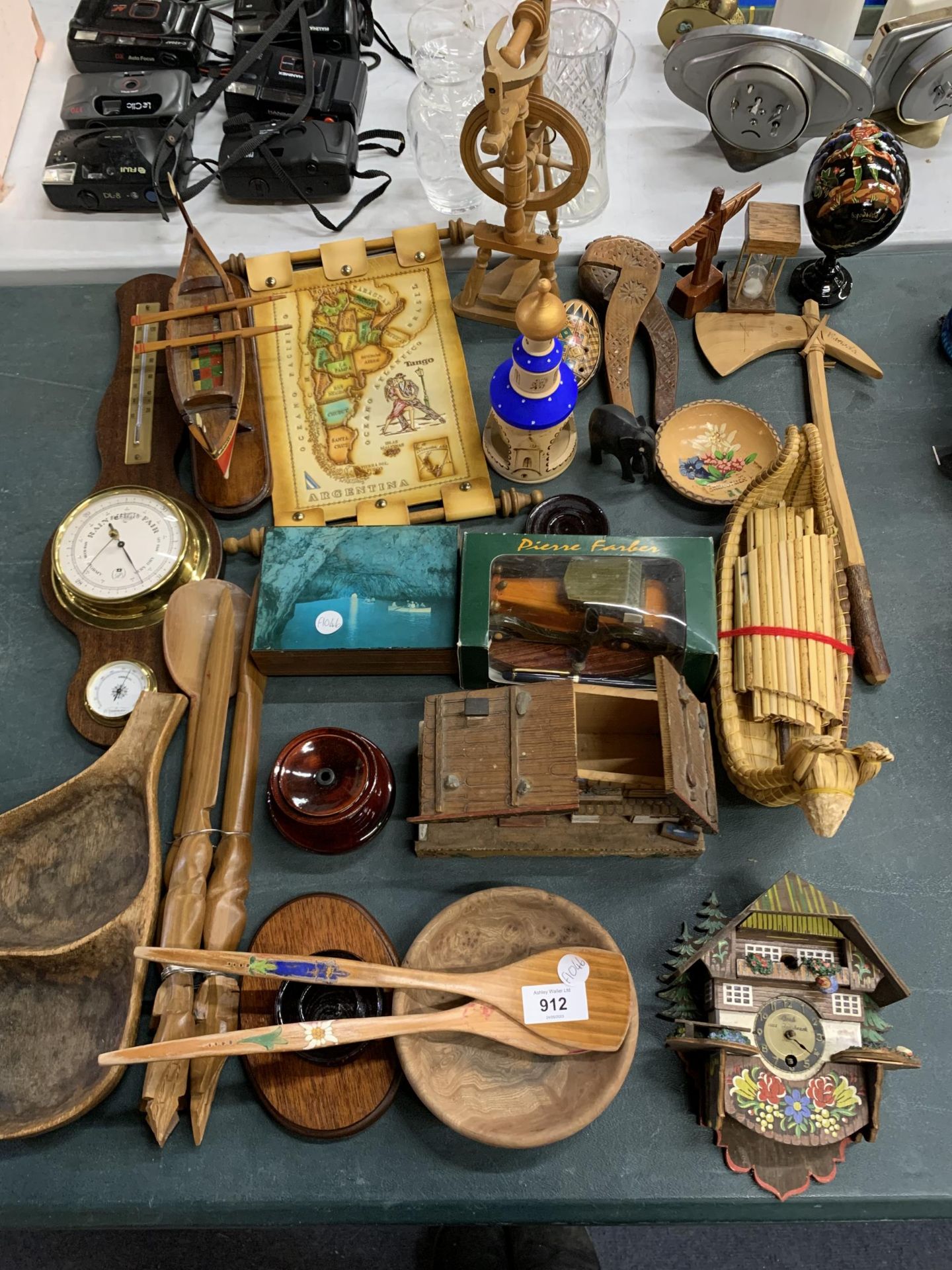 A LARGE QUANTITY OF TREEN ITEMS TO INCLUDE A BAROMETER, SWISS STYLE CLOCK AND HOUSE, A BOAT,