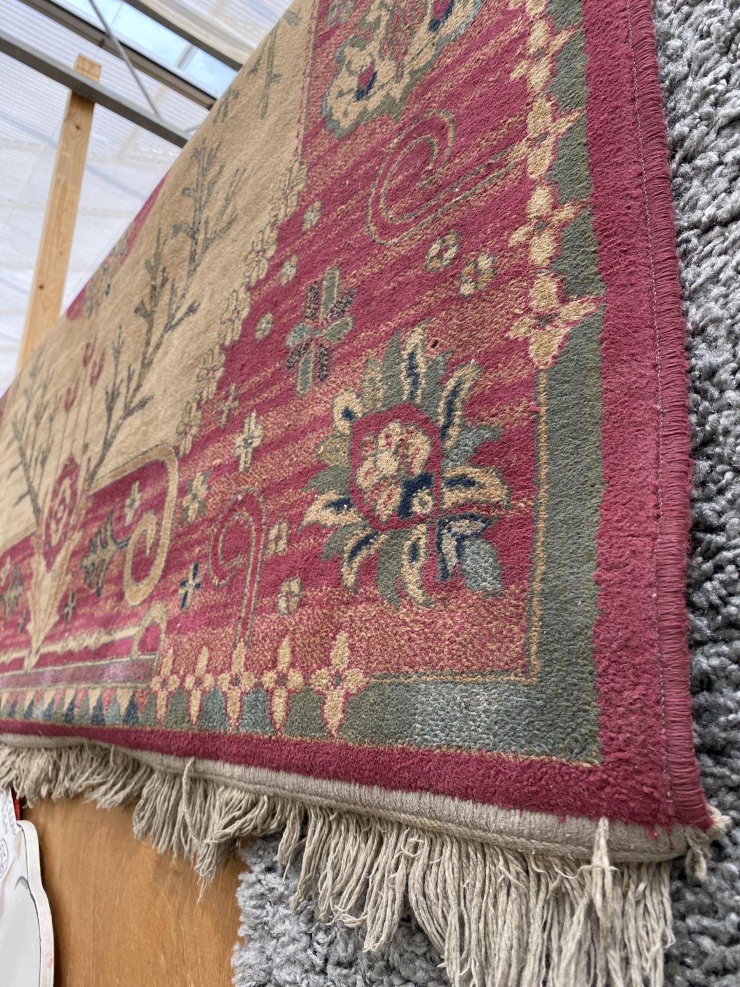 A RED PATTERNED FRINGED RUG - Image 2 of 2