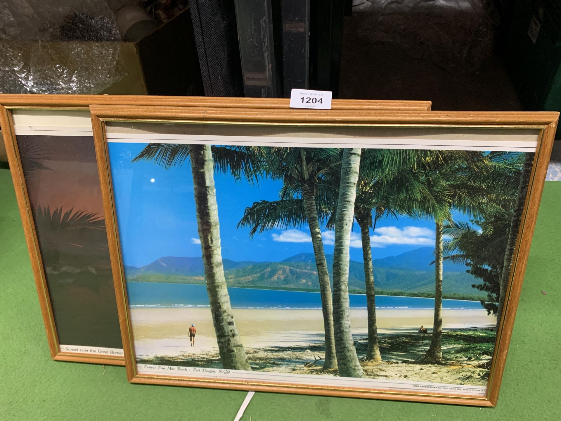 TWO FRAMED PRINTS, ONE OF SUNSET OVER THE GREAT BARRIER REEF, THE OTHER FOUR MILE BEACH, PORT