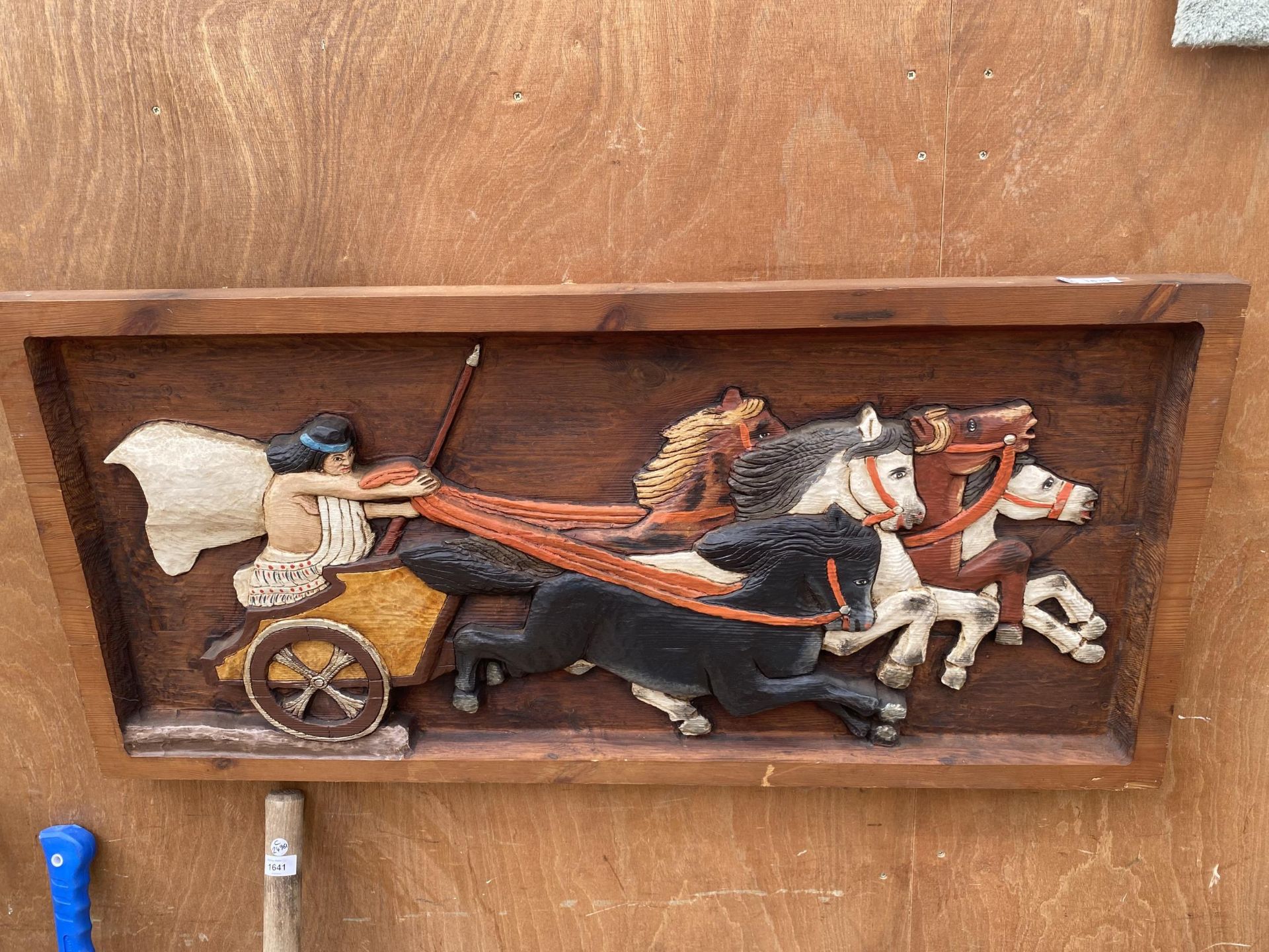 A CARVED WOODEN PLAQUE OF A ROMAN HORSE AND CART