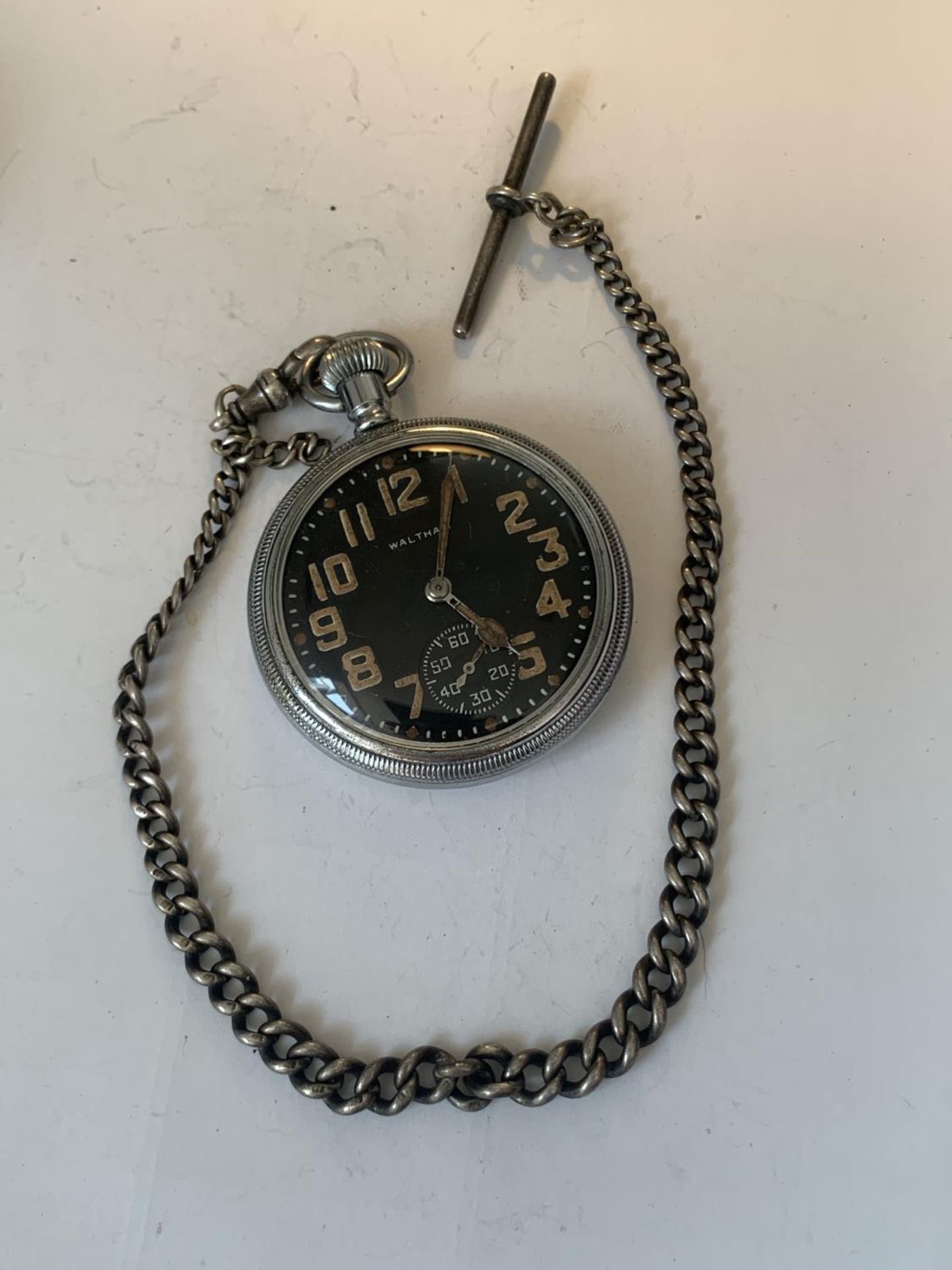 A MILITARY WALTHAM POCKET WATCH ON A MARKED SILVER T BAR CHAIN