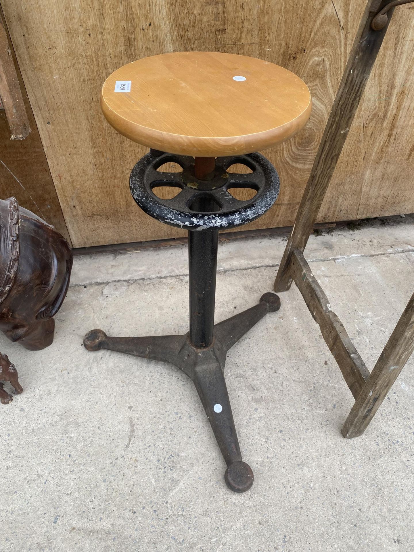 AN INDUSTRIAL ADJUSTABLE STOOL WITH CAST BASE