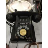 A VINTAGE BLACK BAKELITE ROTARY DIAL TELEPHONE