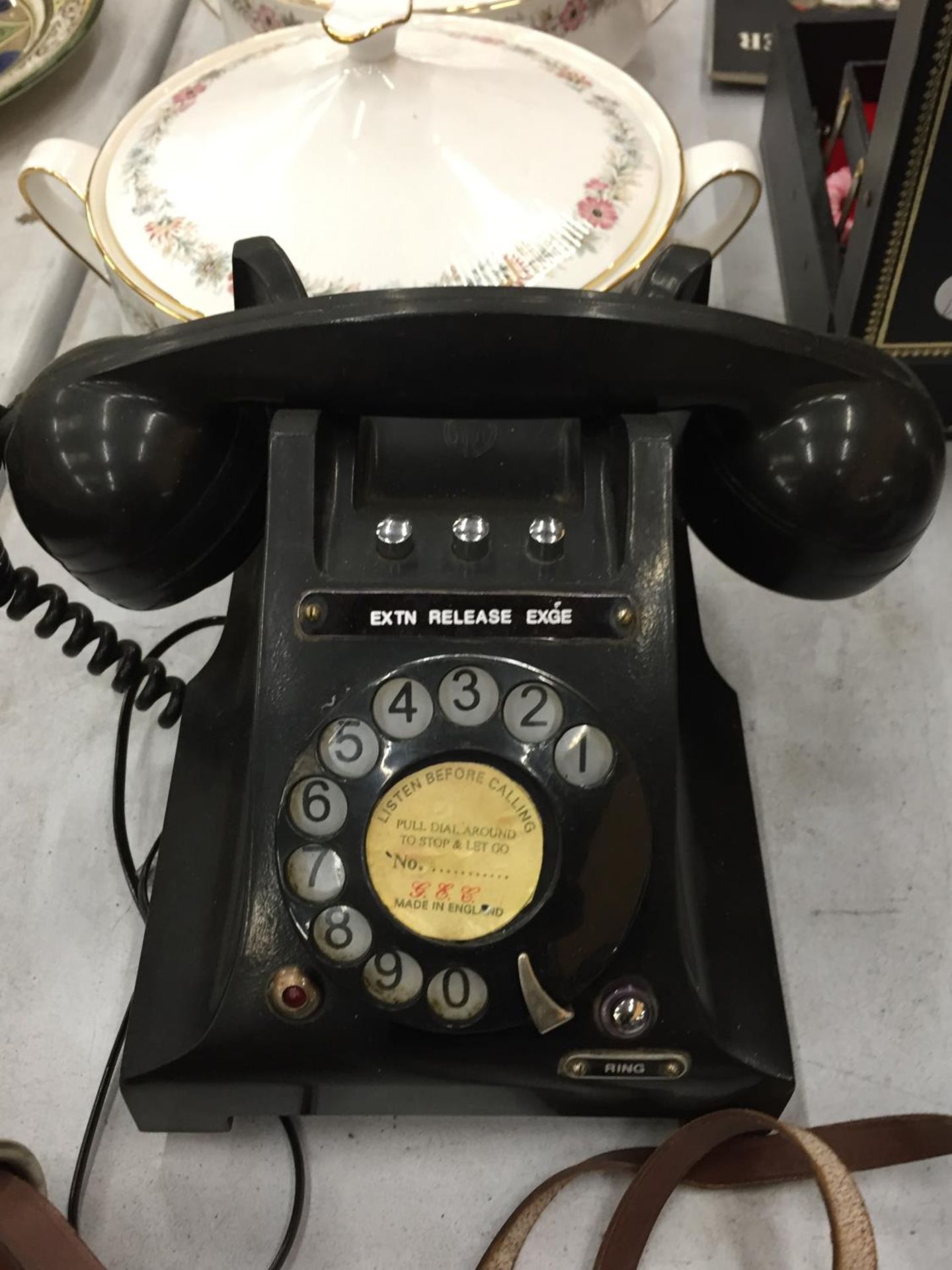 A VINTAGE BLACK BAKELITE ROTARY DIAL TELEPHONE