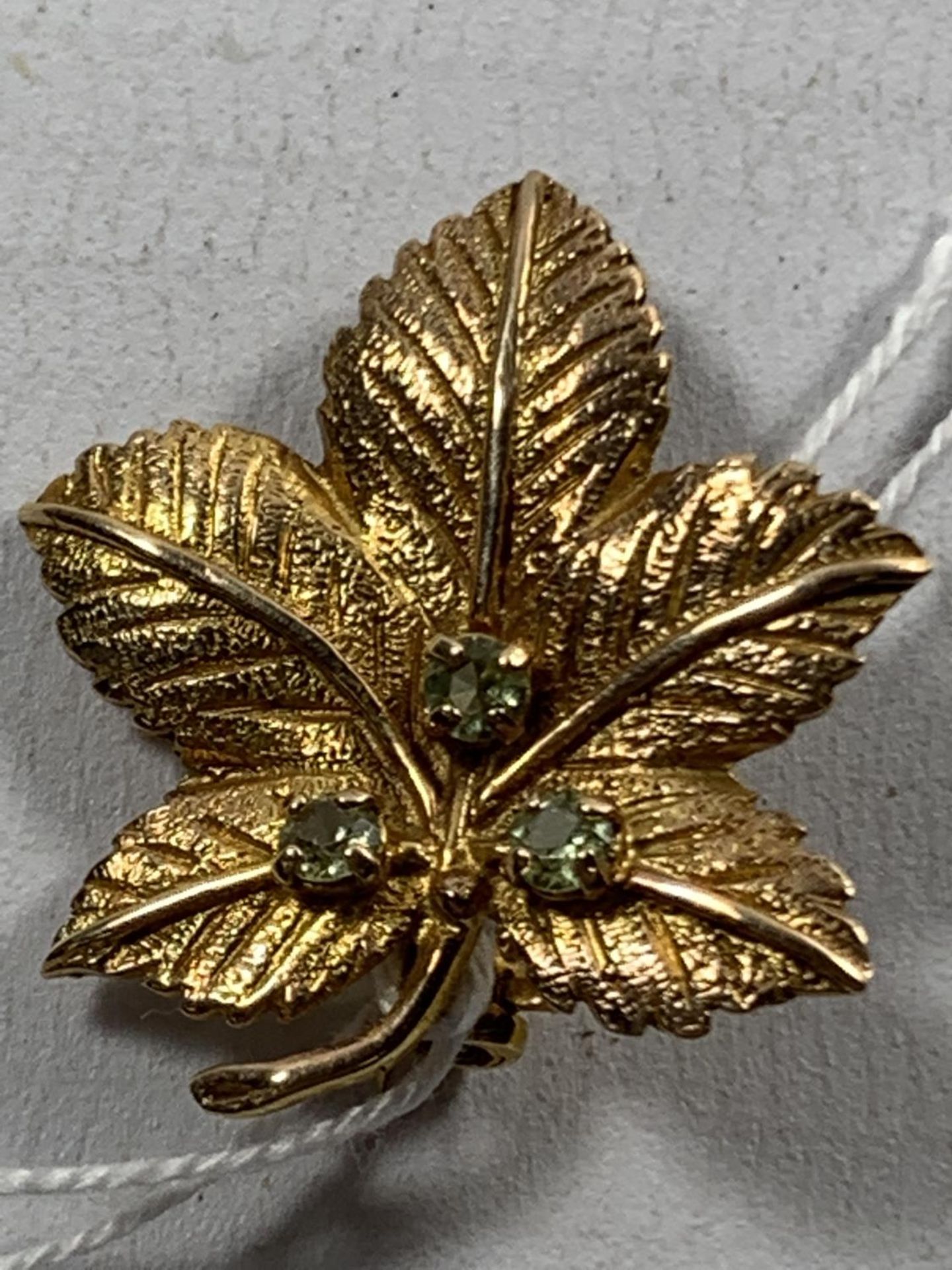 A 9 CARAT GOLD MAPLE LEAF BROOCH WITH THREE STONES GROSS WEIGHT 4 GRAMS