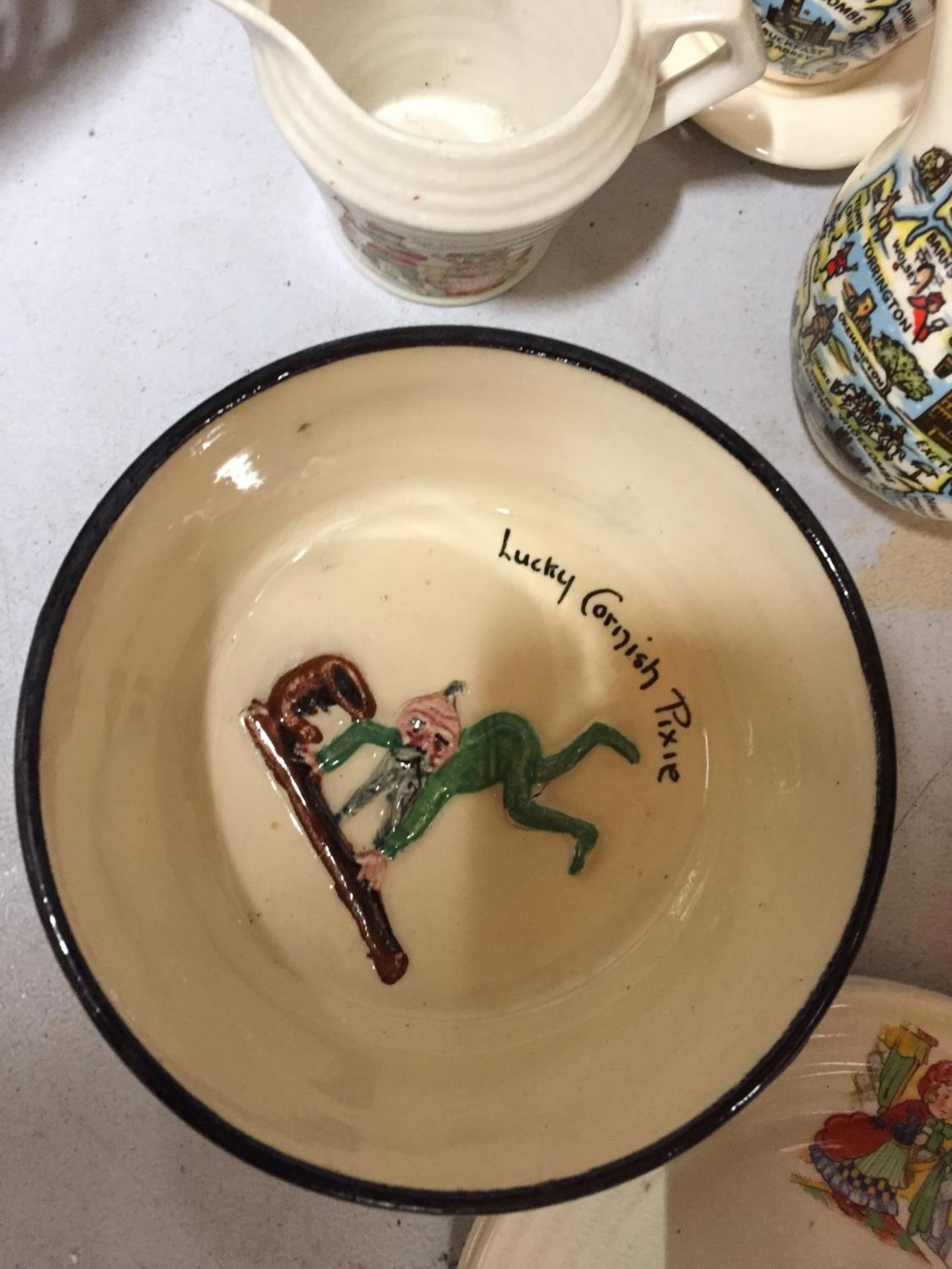 A TORQUAY WARE 'LUCKY CORNISH PIXIE' BOWL, LITTLE RED RIDING HOOD CUPS AND SAUCERS, COLOURED GLASS - Image 2 of 4