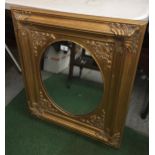 A DECORATIVE GILT FRAMED MIRROR