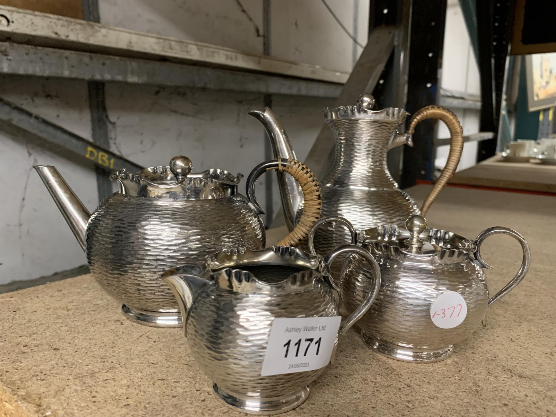 A FOUR PIECE SILVER PLATED TEA SET WITH ABSTRACT DESIGN