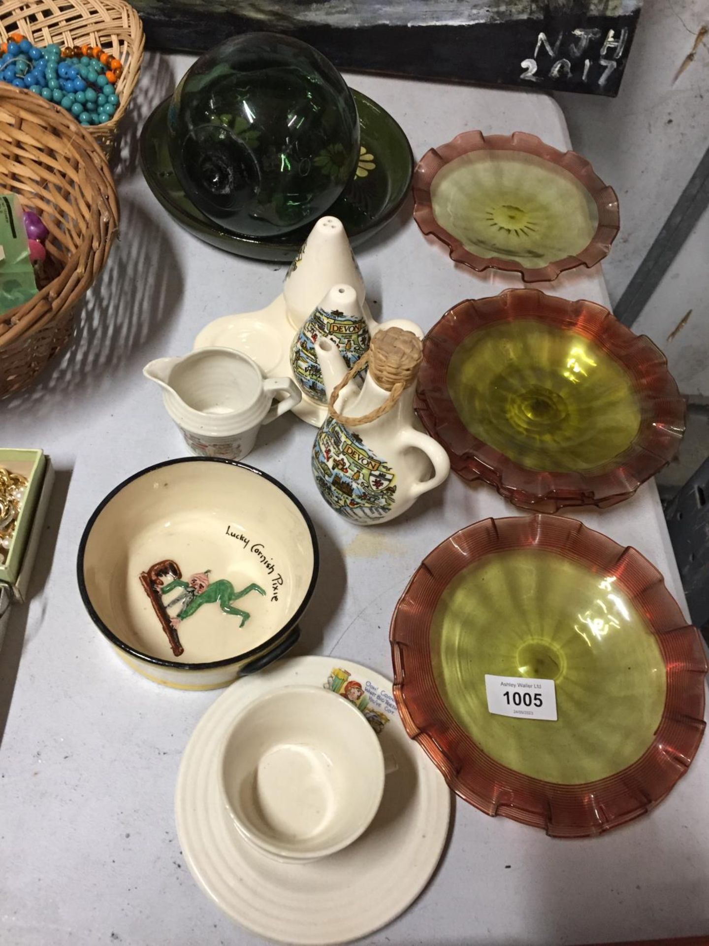 A TORQUAY WARE 'LUCKY CORNISH PIXIE' BOWL, LITTLE RED RIDING HOOD CUPS AND SAUCERS, COLOURED GLASS