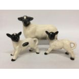 A COOPERCRAFT SHEEP WITH TWO LAMBS
