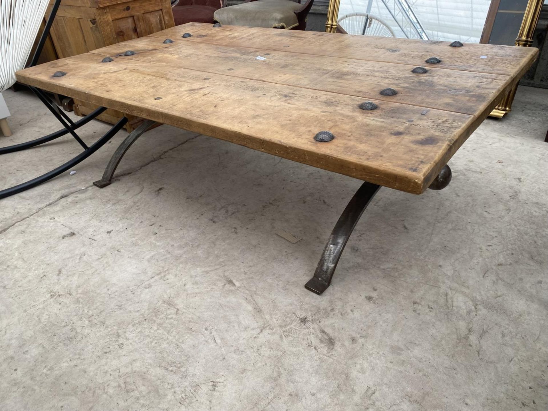 A RUSTIC THREE PLANK LOW TABLE ON METALWARE BASE WITH TWELVE STUDS, 60X35" - Image 2 of 4