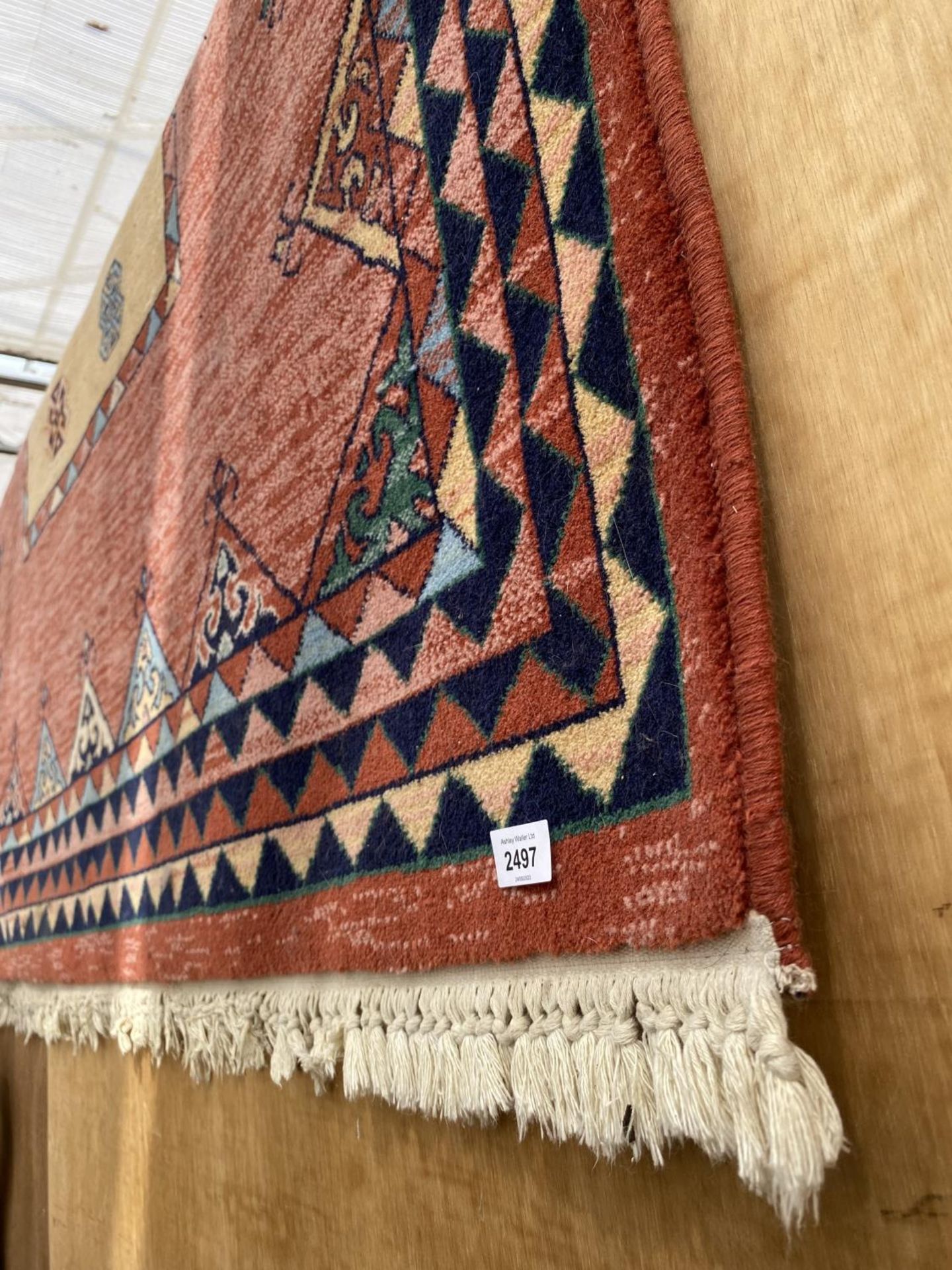 A RED PATTERNED FRINGED RUG - Image 2 of 2