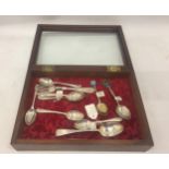 A DISPLAY BOX CONTAINING ASSORTED HALLMARKED SILVER FLATWARE - SET OF FOUR, ENAMEL TOP EXAMPLES,