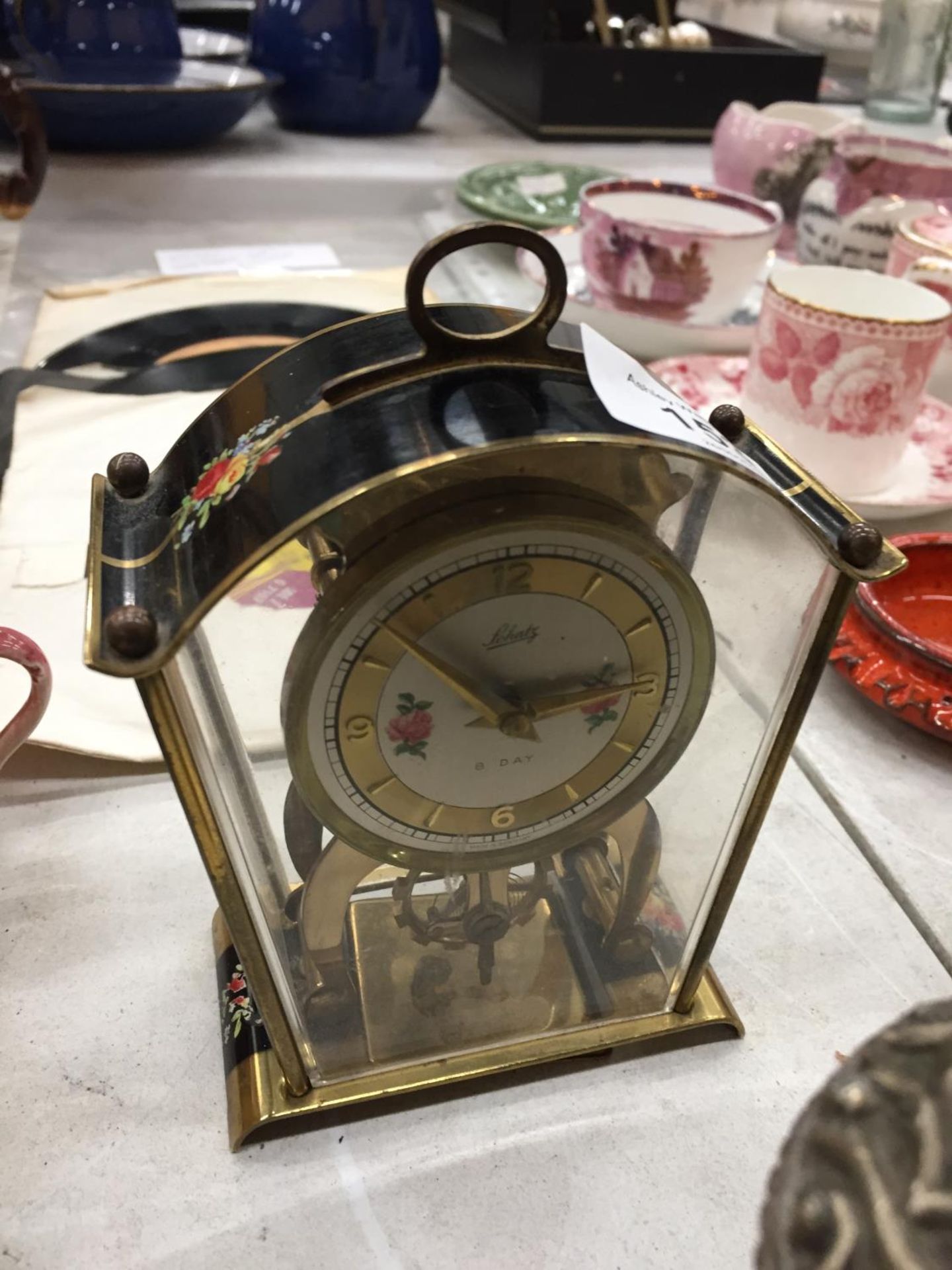 A SMALL GERMAN MANTLE CLOCK WITH FLORAL PATTERN