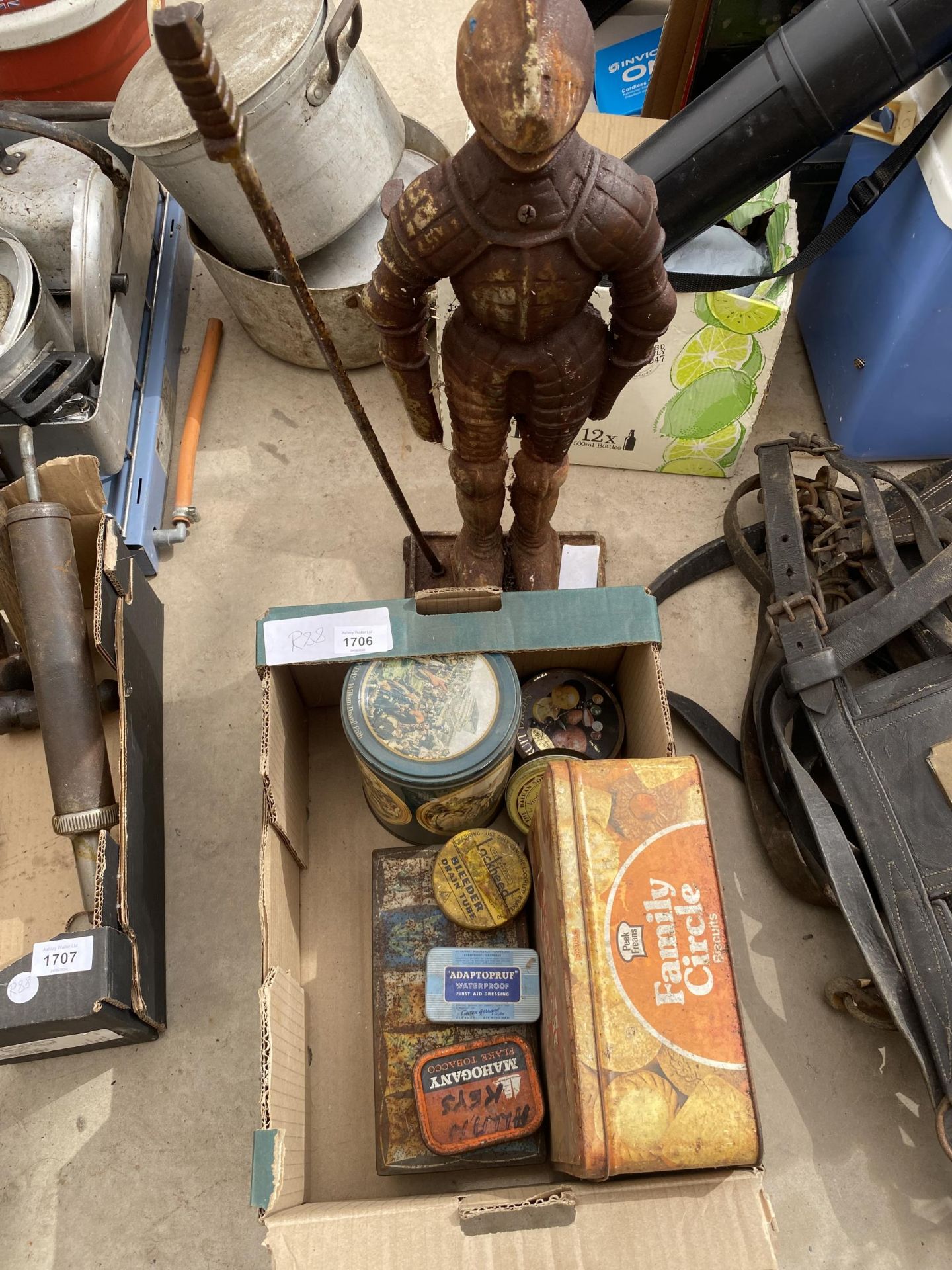 A BOX OF VINTAGE TINS AND CAST SUIT OF ARMOUR COMPANION STAND