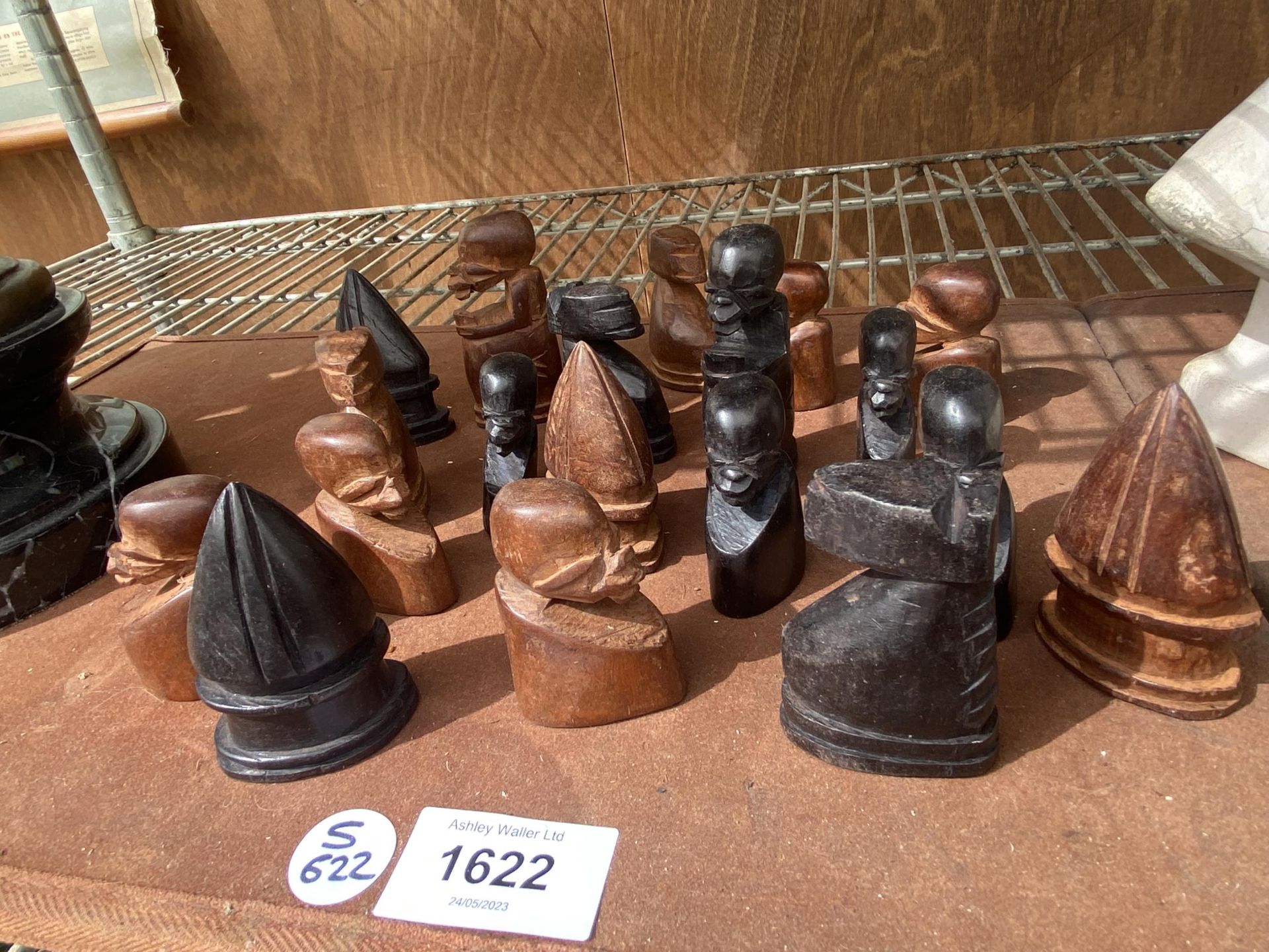 A COLLECTION OF TRIBAL CARVED WOODEN CHESS PIECES