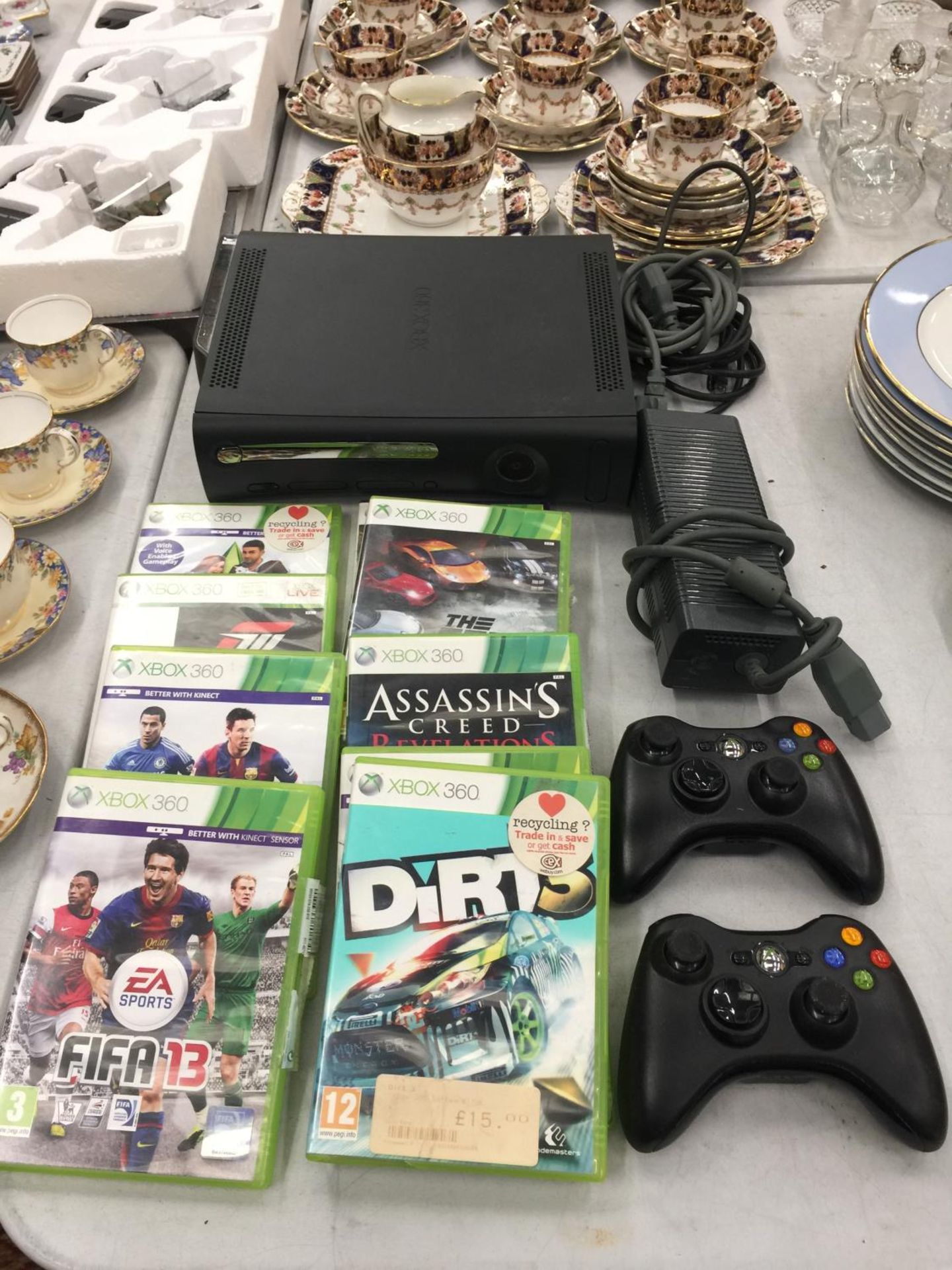 AN X-BOX 360 CONSOLE, POWER PACK, CONTROLLERS AND A QUANTITY OF GAMES TO INCLUDE FIFA '13, '14