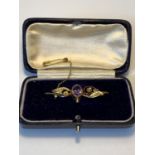 A 9 CARAT GOLD BROOCH WITH AMETHYST AND SEE PEARLS GROSS WEIGHT 2.52 GRAMS IN A PRESENTATION BOX