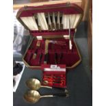 A BOXED PART CANTEEN OF CUTLERY WITH BRASS BOWLS AND ORIENTAL DESIGN TO THE HANDLES PLUS LARGE