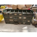 A VINTAGE INDUSTRIAL GREEN METAL EIGHTEEN DRAWER CABINET (LACKING TOP)