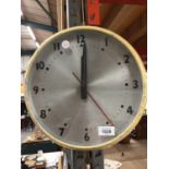 A VINTAGE ELECTRIC METAL WALL CLOCK