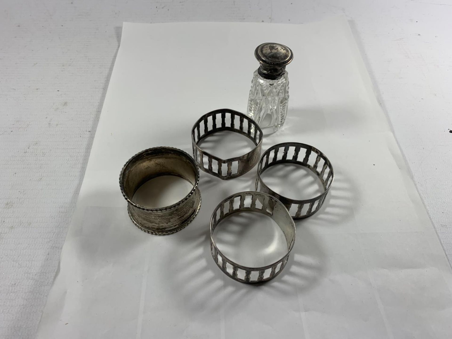 FOUR SILVER NAPKIN RINGS AND A SILVER LIDDED PERFUME BOTTLE WITH STOPPER - Image 2 of 6