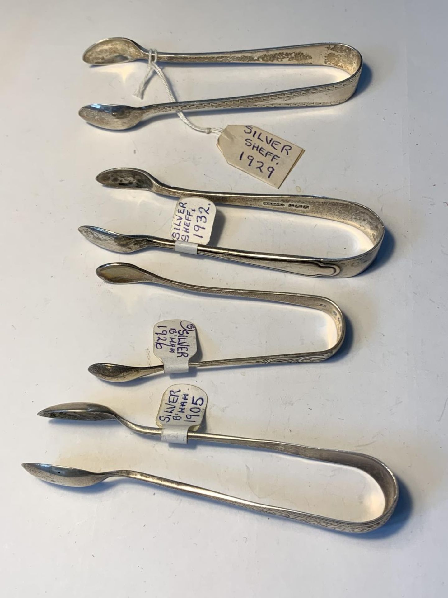 FOUR SETS OF SUGAR NIPS TWO HALLMARKED SHEFFIELD 1929 AND 1932 AND TWO BIRMINGHAM 1905 AND 1926