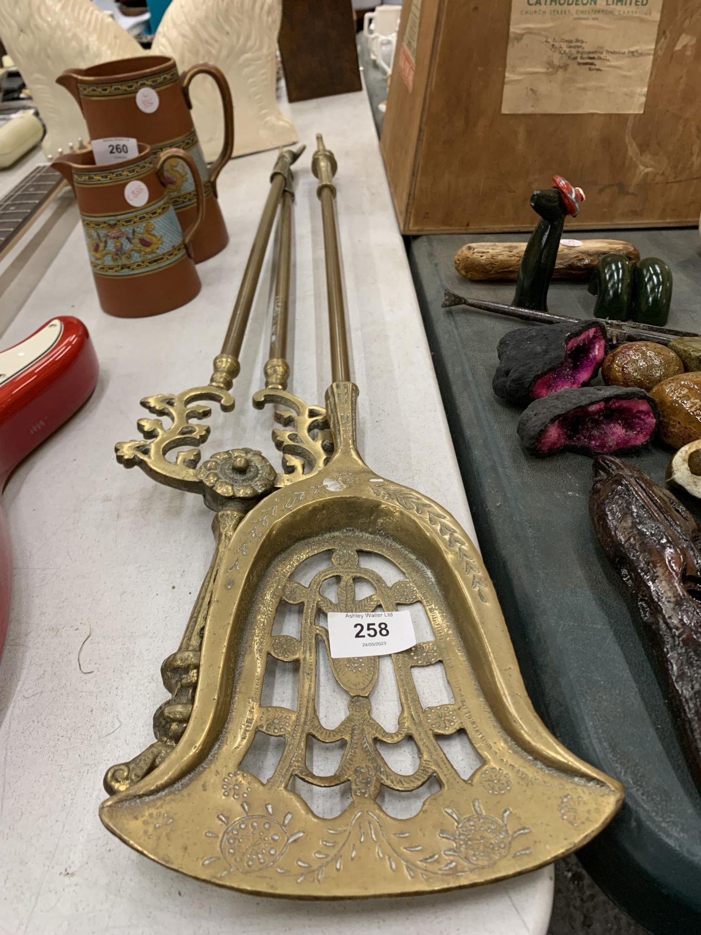 A LARGE BRASS SHOVEL AND TONGS