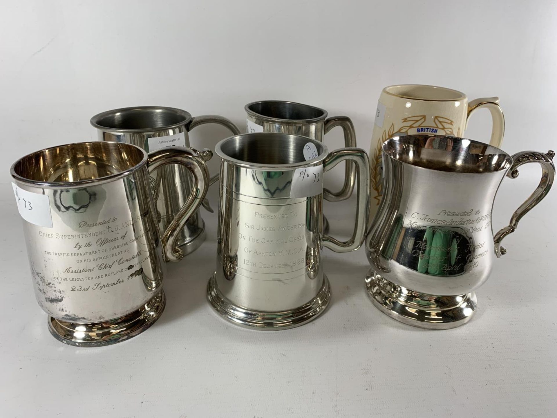 * A COLLECTION OF SIX PRESENTATION MUGS TO INCLUDE SILVER PLATED, THREE PEWTER AND CERAMIC EXAMPLES