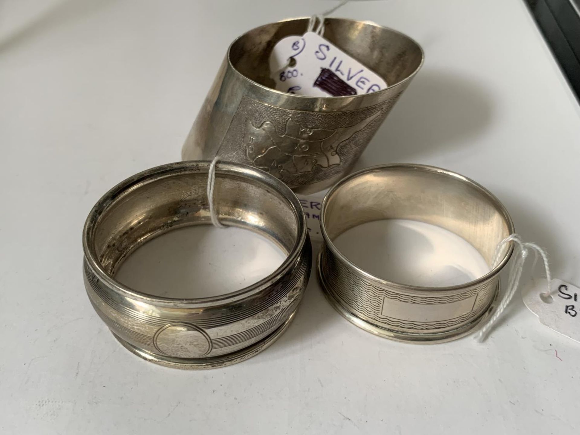 TWO HALLMARKED BIRMINGHAM SILVER NAPKIN RINGS AND A FURTHER SILVER RING WITH A MAP OF CYPRUS - Image 2 of 3