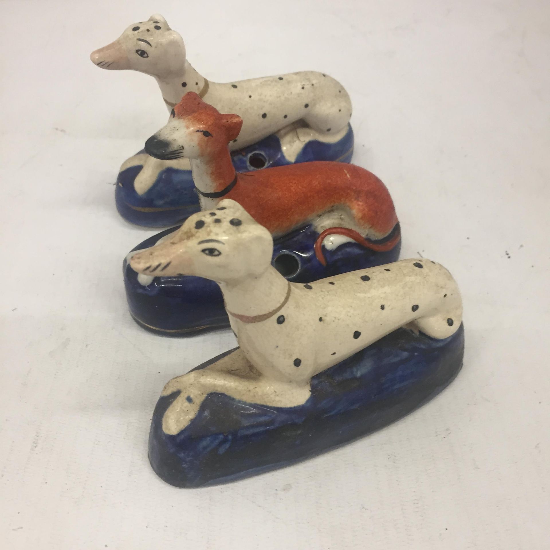 A PAIR OF STAFFORDSHIRE DALMATION INKWELLS AND FURTHER GREYHOUND EXAMPLE