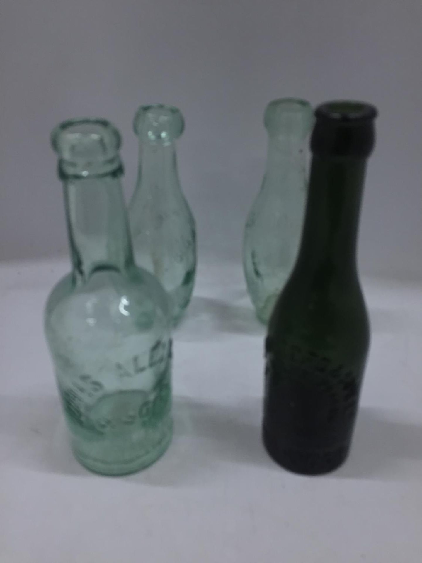 FOUR VINTAGE GLASS BOTTLES