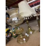 TWO TABLE LAMPS, ONE BRASS, THE OTHER IN THE STYLE OF AN OIL LAMP