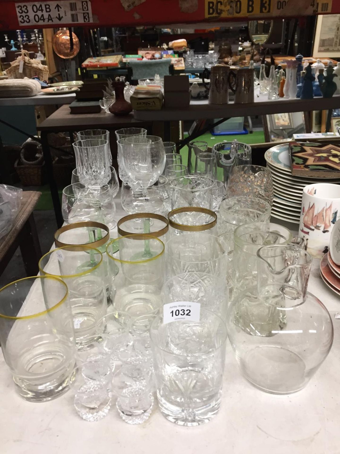 A QUANTITY OF GLASSWARE TO INCLUDE WINE GLASSES, TUMBLERS, SHOT GLASSES, ETC.,