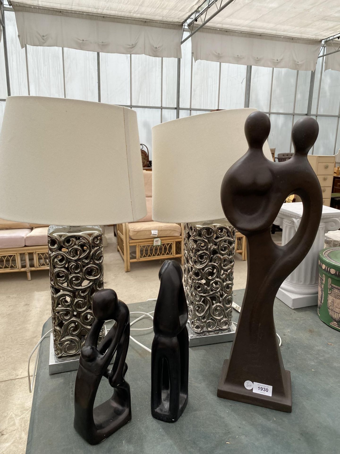 A PAIR OF ABSTRACT SILVER LAMPS AND THREE FIGURES