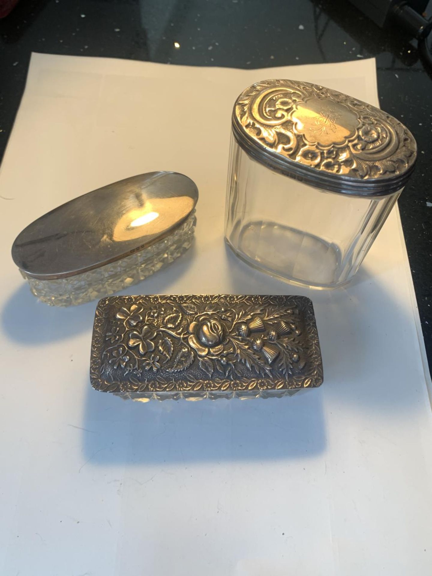 THREE GLASS DRESSING TABLE POTS WITH HALLMARKED SILVER LIDS TWO LONDON AND ONE BIRMINGHAM