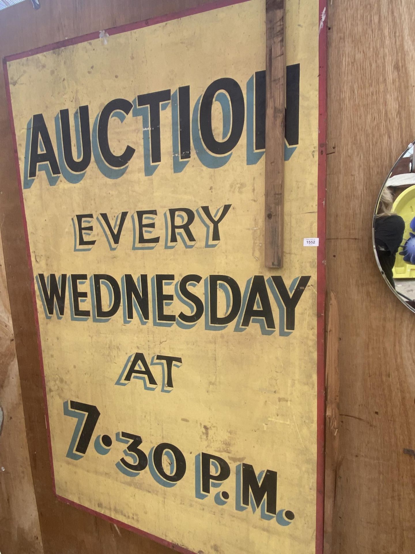 A VINTAGE WOODEN 'AUCTION EVERY WEDNESDAY' SIGN