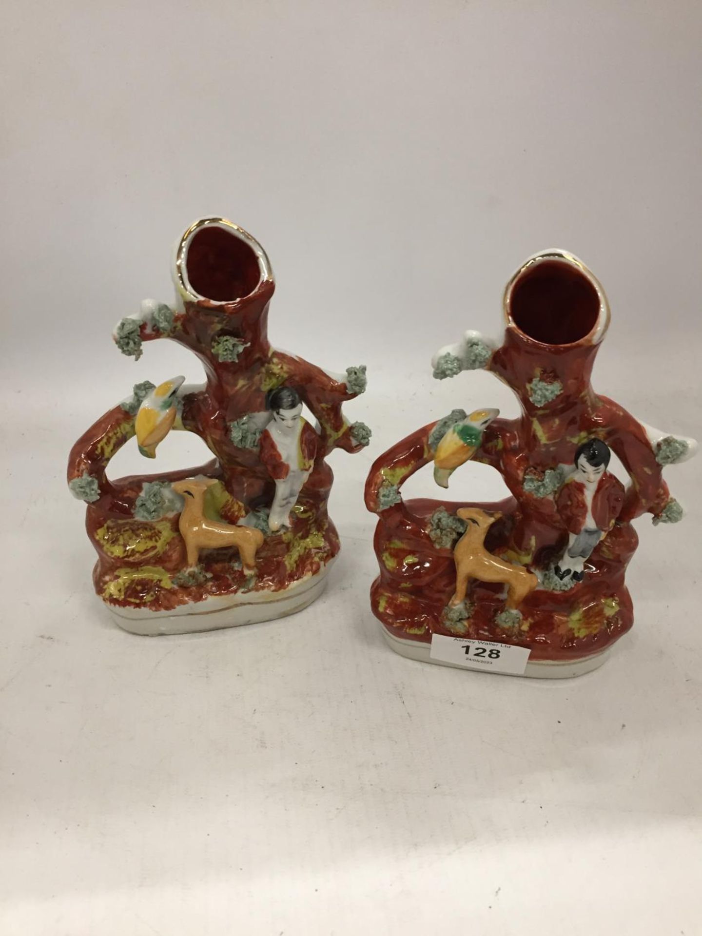 A PAIR OF VINTAGE STAFFORDSHIRE STYLE SPILL HOLDERS WITH FIGURE AND FAUNA DECORATION HEIGHT 17.5CM
