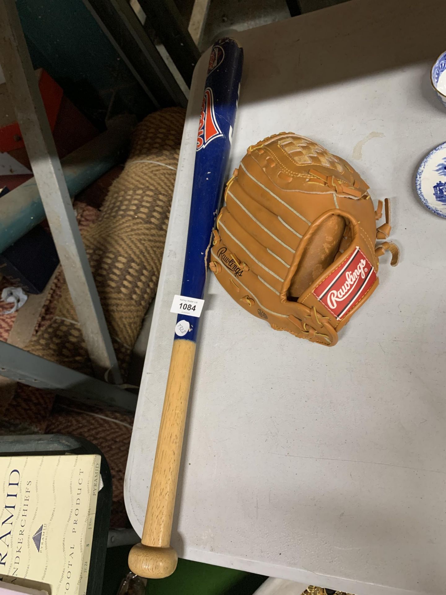 A RAWLINGS BASEBALL GLOVE AND NETS BASEBALL BAT