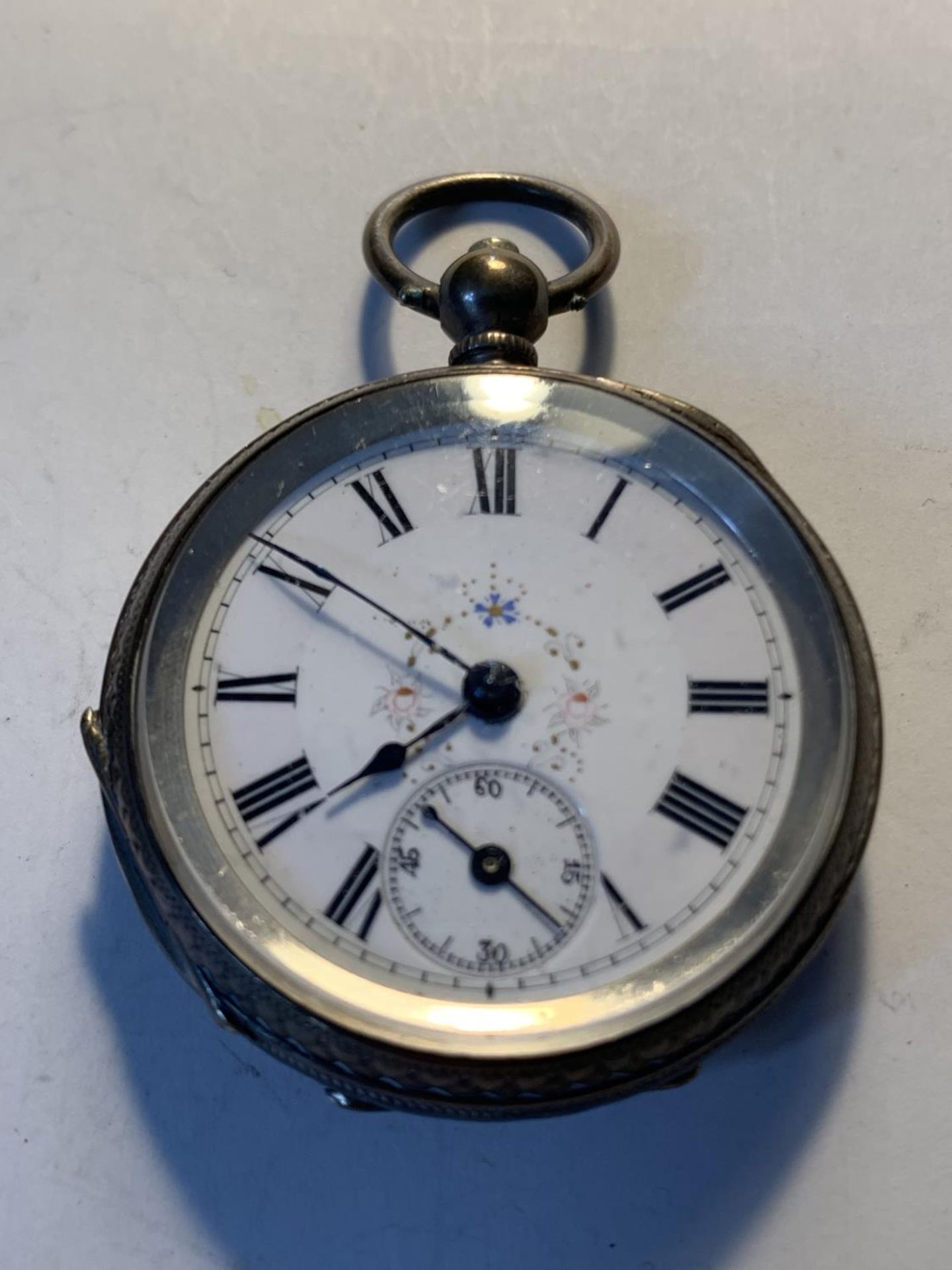 AN 800 SILVER POCKET WATCH WITH SUB DIAL, DECORATIVE WHITE ENAMEL FACE, ROMAN NUMERALS AND A KEY - Image 2 of 4